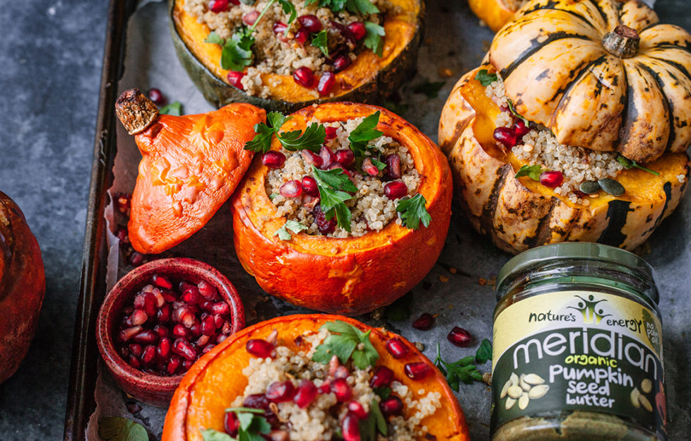 4 mini pumpkins of different colours, tops sliced off, filled with grain mix, cranberries and pomegranate seeds, scattered with fresh herbs, jar of Meridian pumpkin seed butter on the side