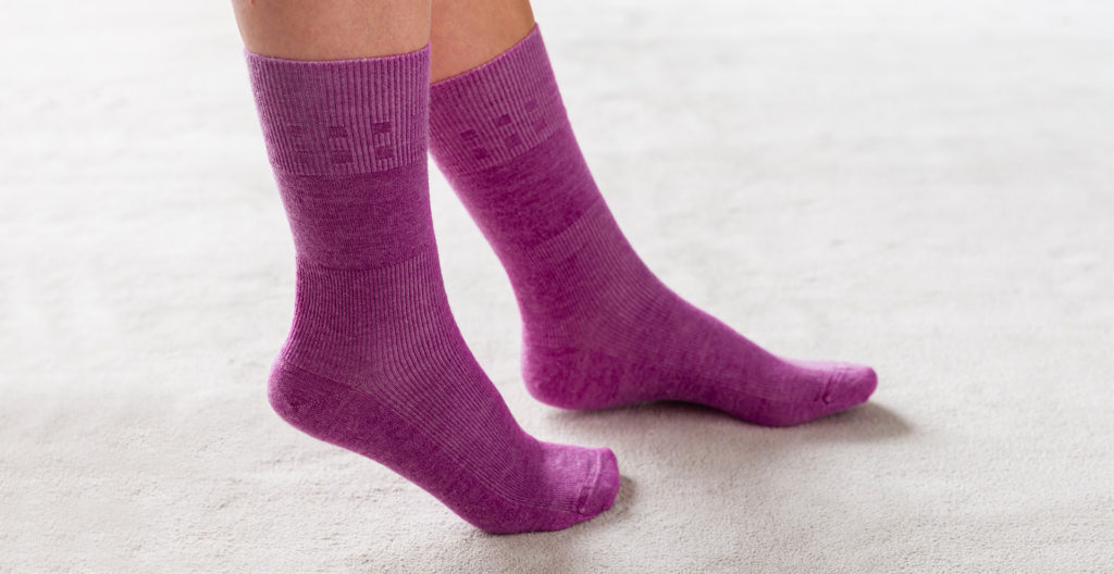 Pair of purple socks on feet