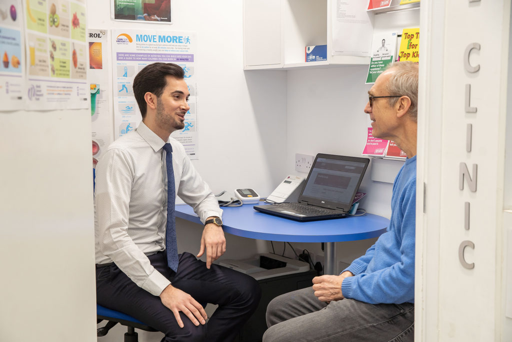 Pharmacist talking to customer