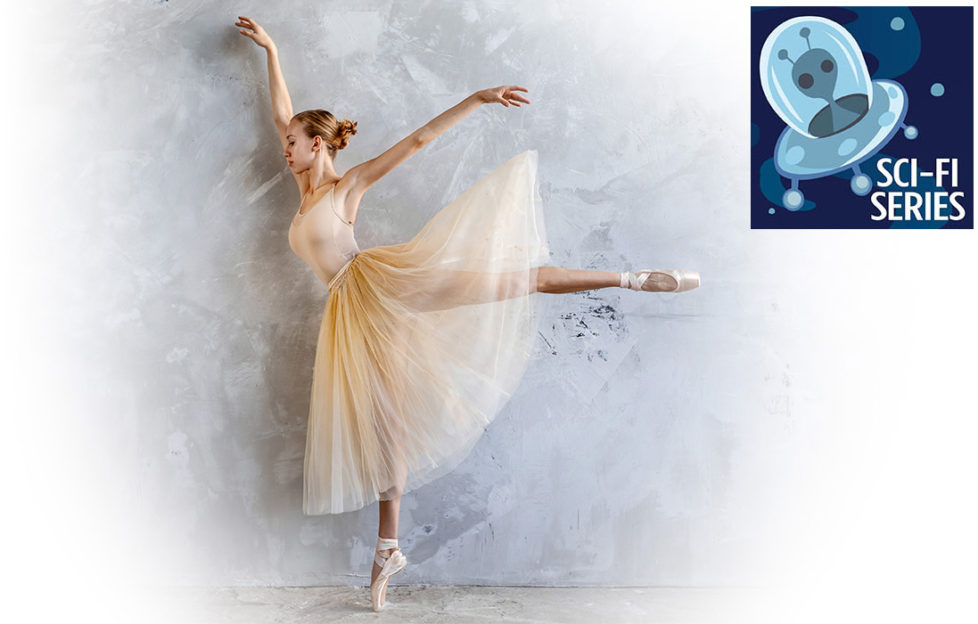 Young slim ballerina in a golden colored dancing costume is posing in a loft studio