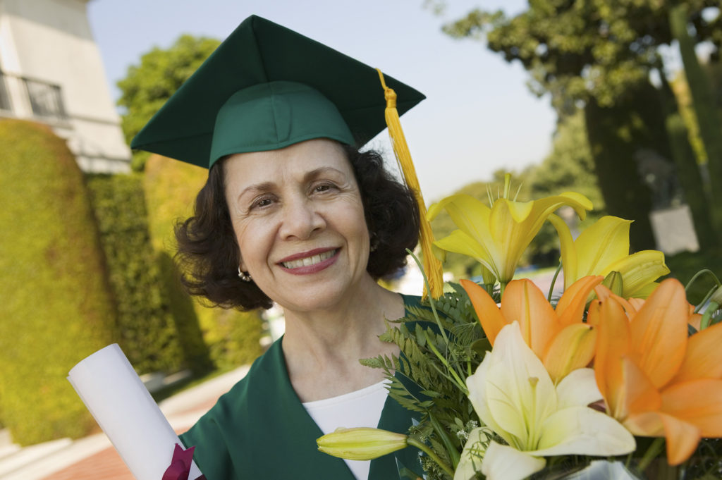 Graduate Holding Diploma and Flowers