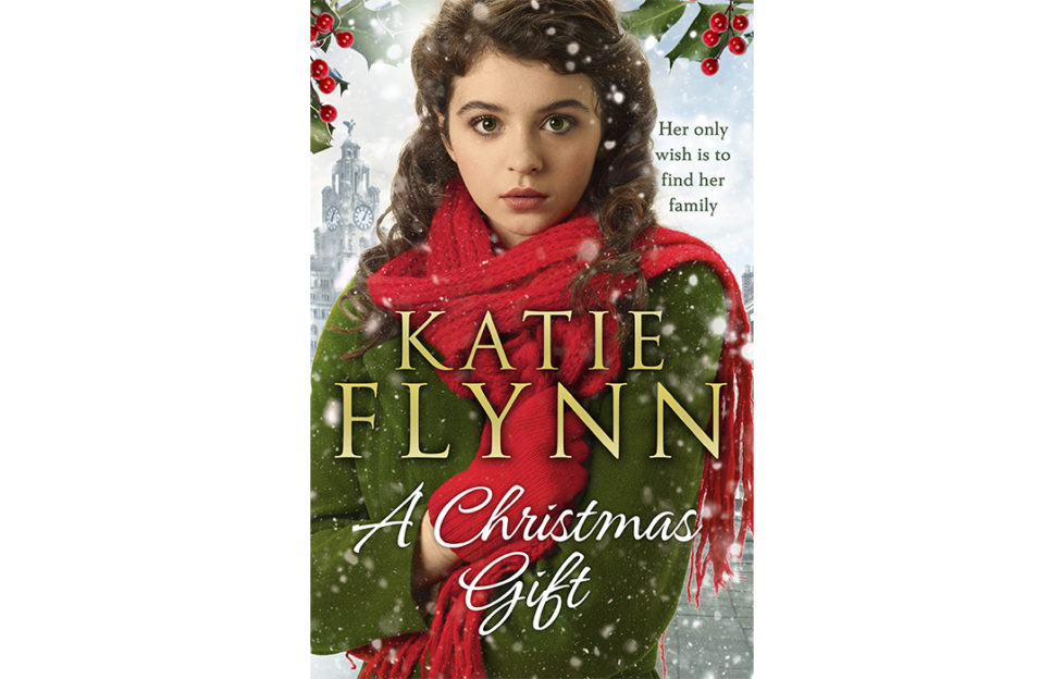 Cover of A Christmas Gift. Photo of teenage girl in coat and scarf, with wide anxious eyes. It's snowing