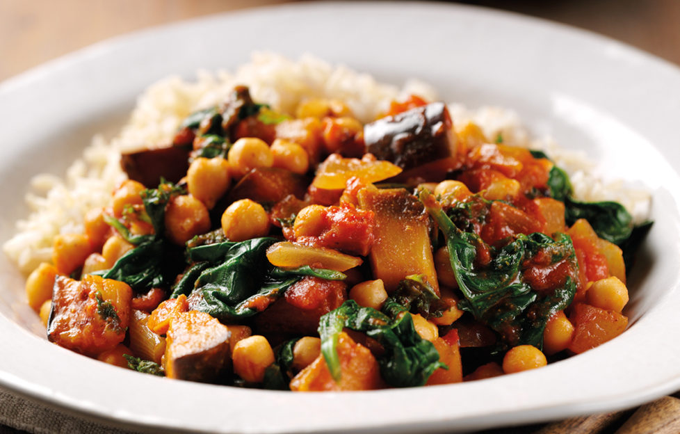 Bowl of spinach and aubergine curry with chickpeas and tomato