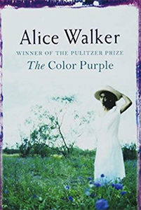 Cover of The Color Purple, photo of young black girl in a green field, wearing a white dress, holding a straw hat onto her head