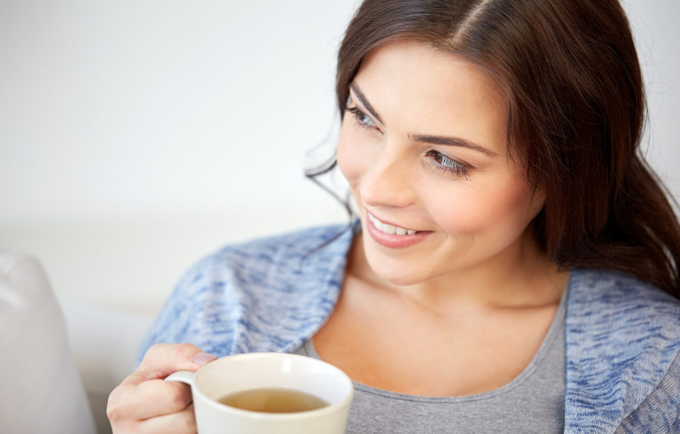 Woman sipping cup of tea