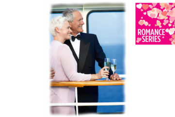Mature couple in evening dress with glasses of sparkling wine lean on rail of cruise ship deck