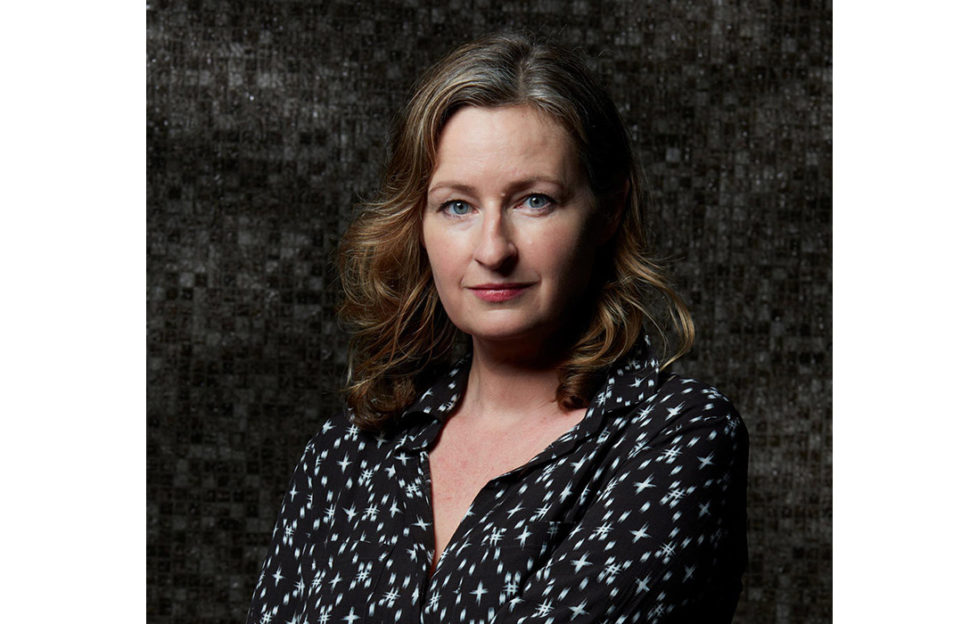 Portrait shot of author Louise Candlish against dark background