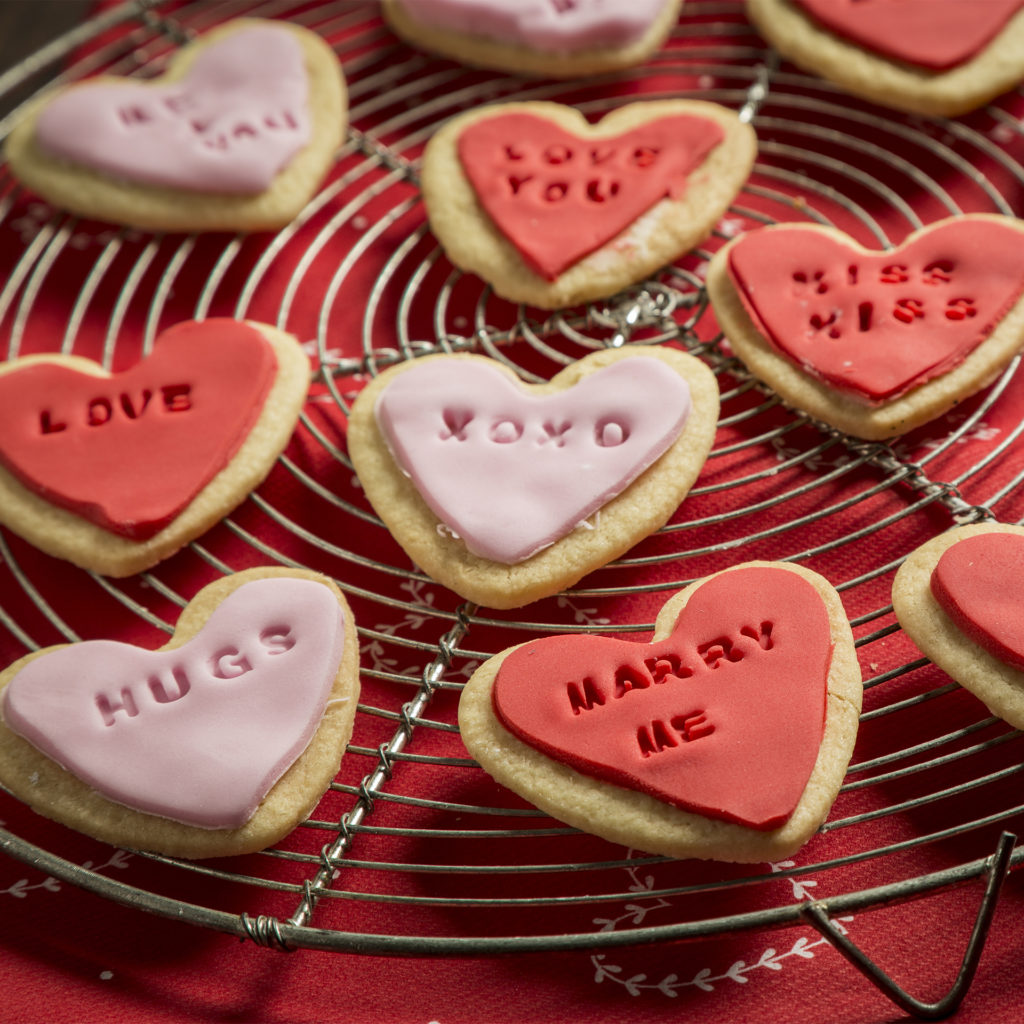 Biscuits in the style of Love Heart sweets, with short slogans in capitals