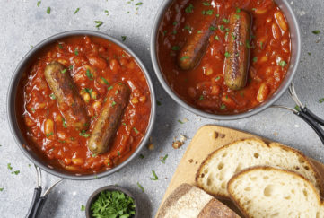 2 bowls of casserole, each with 2 sausages and rich spicy homemade tomato sauce and beans.
