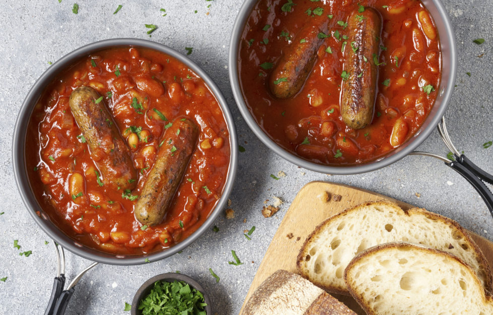 2 bowls of casserole, each with 2 sausages and rich spicy homemade tomato sauce and beans.