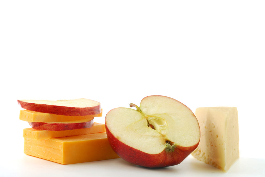 Apple and cheese slices on white background