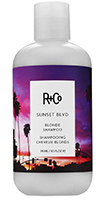 Bottle of R&Co Sunset Boulevard shampoo, white bottle with image of purple and pink sunset