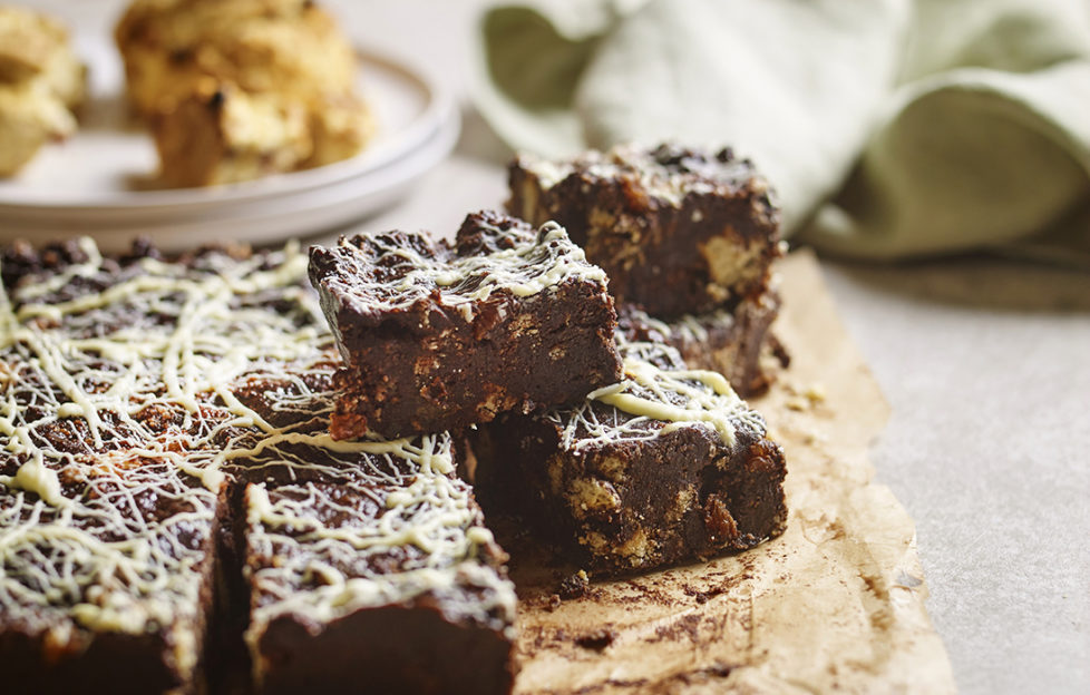 Squares of rich chocolate tiffin topped with squiggles of white chocolate