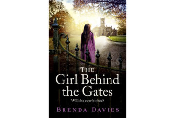 Cover of The Girl Behind The Gates, photo image of teenage girl in purple coat looking towards Victorian hospital building, mature trees around
