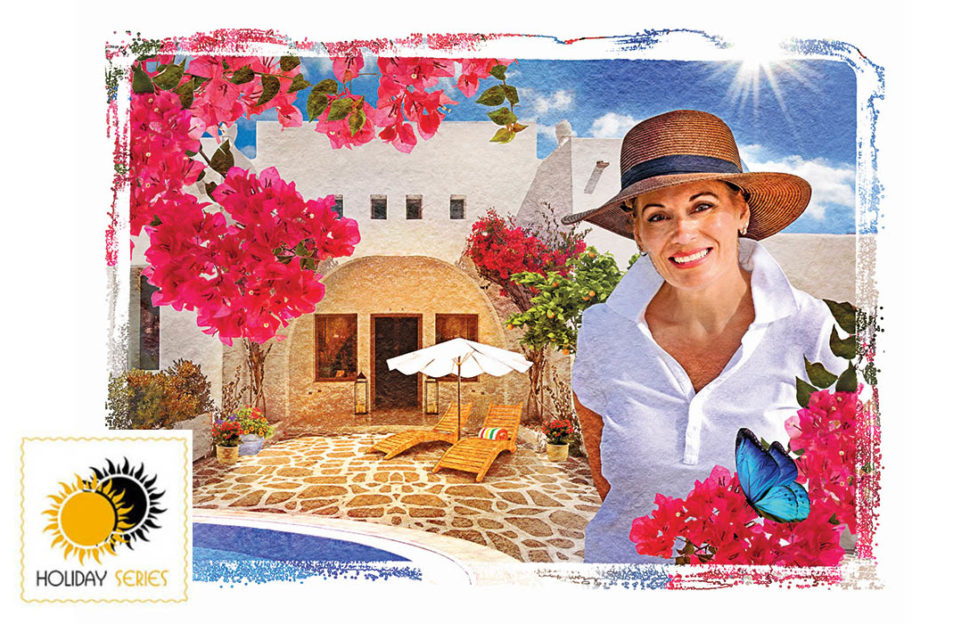 Elegant 50-something grandmother, smiling, in sunhat and white shirt, beautiful Majorcan villa behind with red bougainvillea flowers