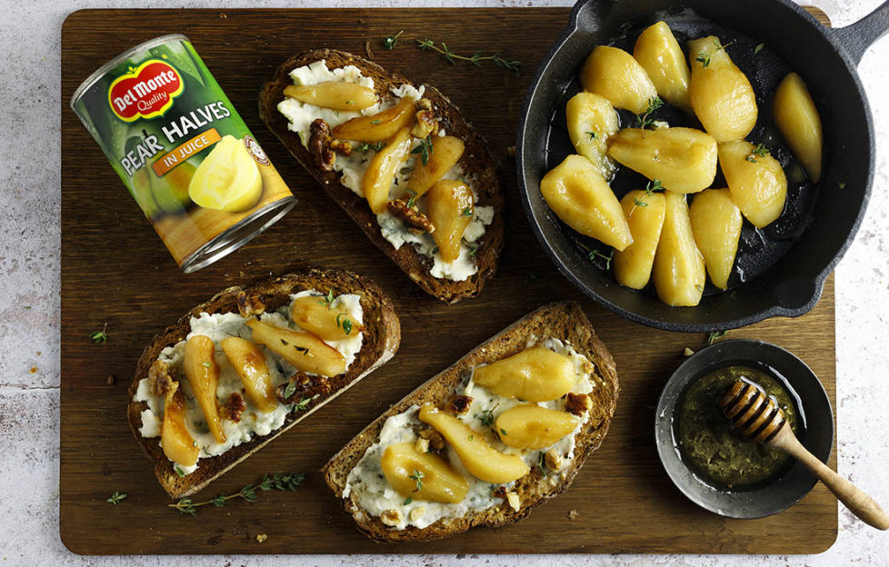 Pan of pears frying in butter, 3 slices of bread spread with blue cheese with pears and walnuts on top, and a can of Del Monte pear halves