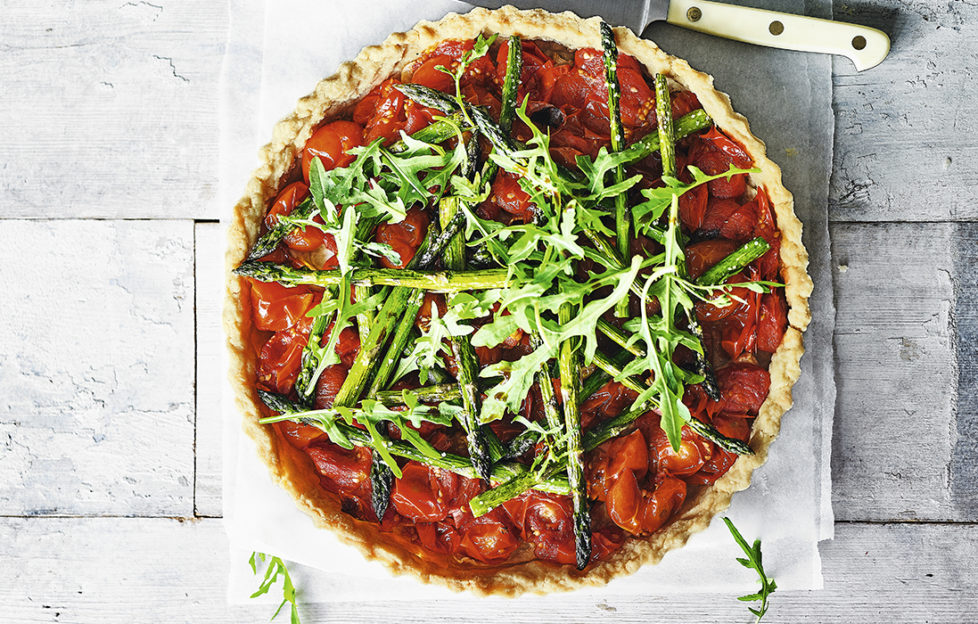 Shortcrust pastry tart, rich confit tomato filling, charred asparagus on top and fresh rocket leaves