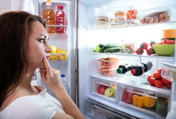 Pretty Woman Looking For Food In Refrigerator