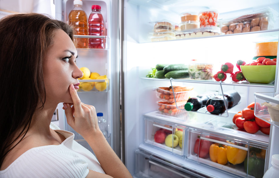 Pretty Woman Looking For Food In Refrigerator