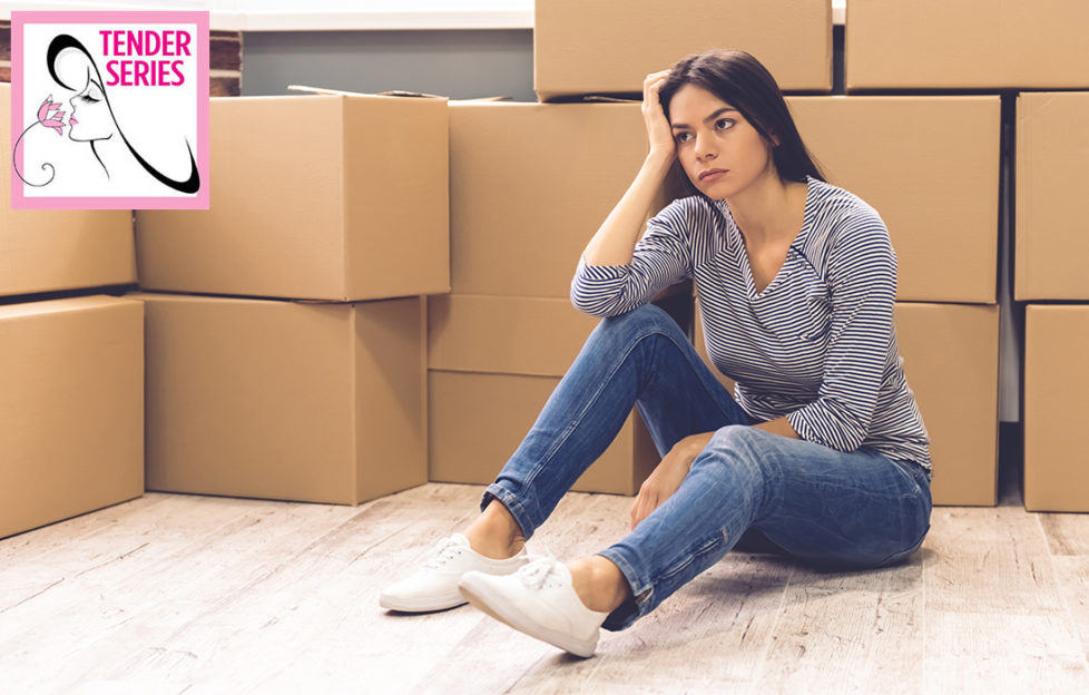 Woman moving away, piles of boxes, looks sad and wistful