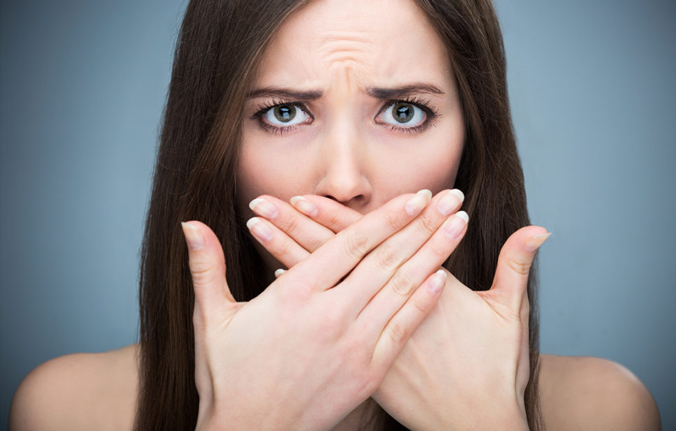 Woman covering mouth