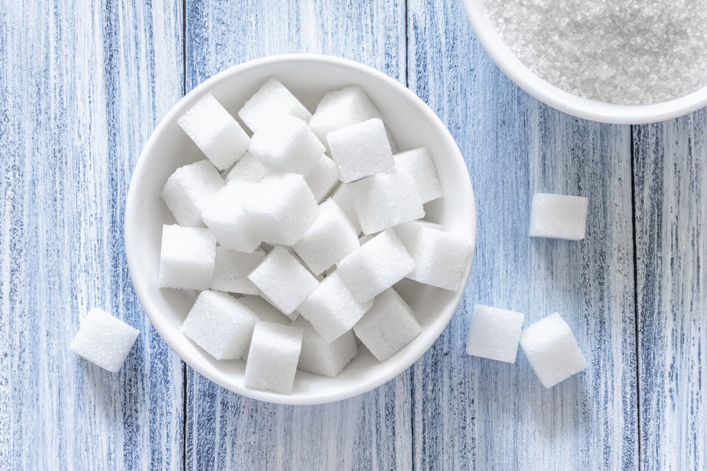 Sugar cubes in white bowl
