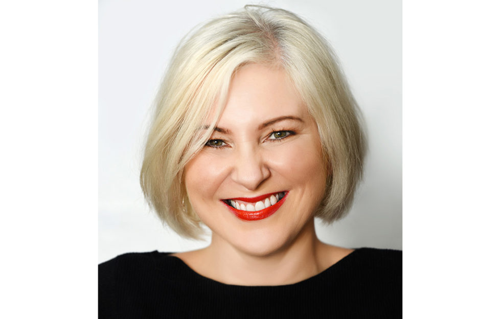 Author Anna McPartlin, smiling woman with red lipstick, blonde bob and black top