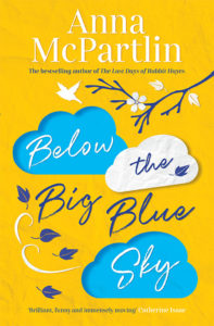 Cover of Below The Big Blue sky, cartoon white and blue clouds on yellow background, whirling leaves and flowers on a branch