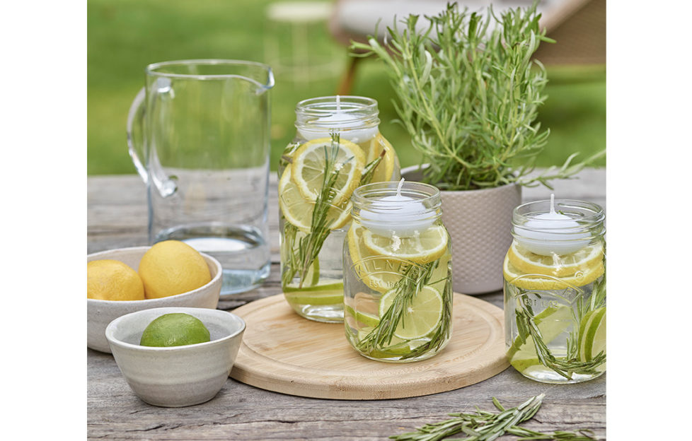 Jars with rosemary, citrus fruit and oils