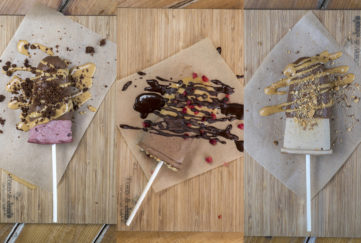 3 home made choc ice lollies on greaseproof paper with sauce drizzled and crushed nuts sprinkled on. 3 different recipes