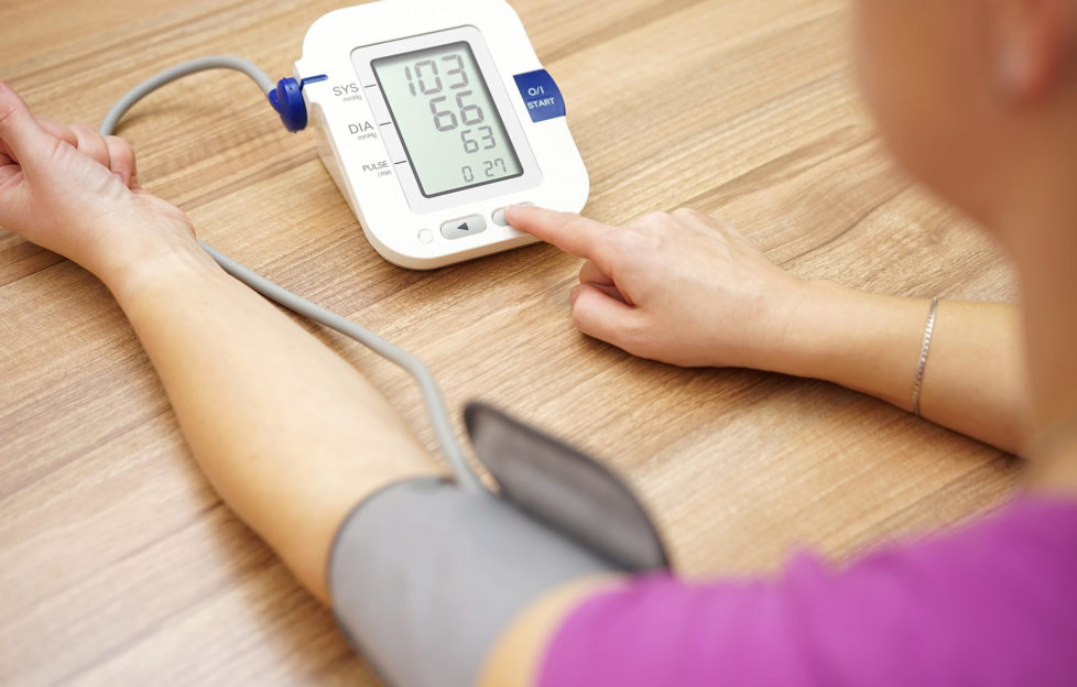 Woman taking her own blood pressure