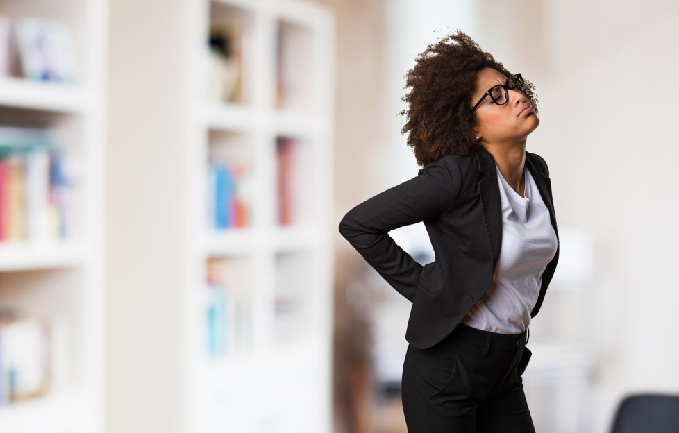 business black woman having a back ache;