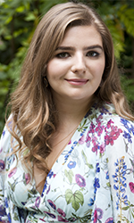 Woman with long brown hair in floral top