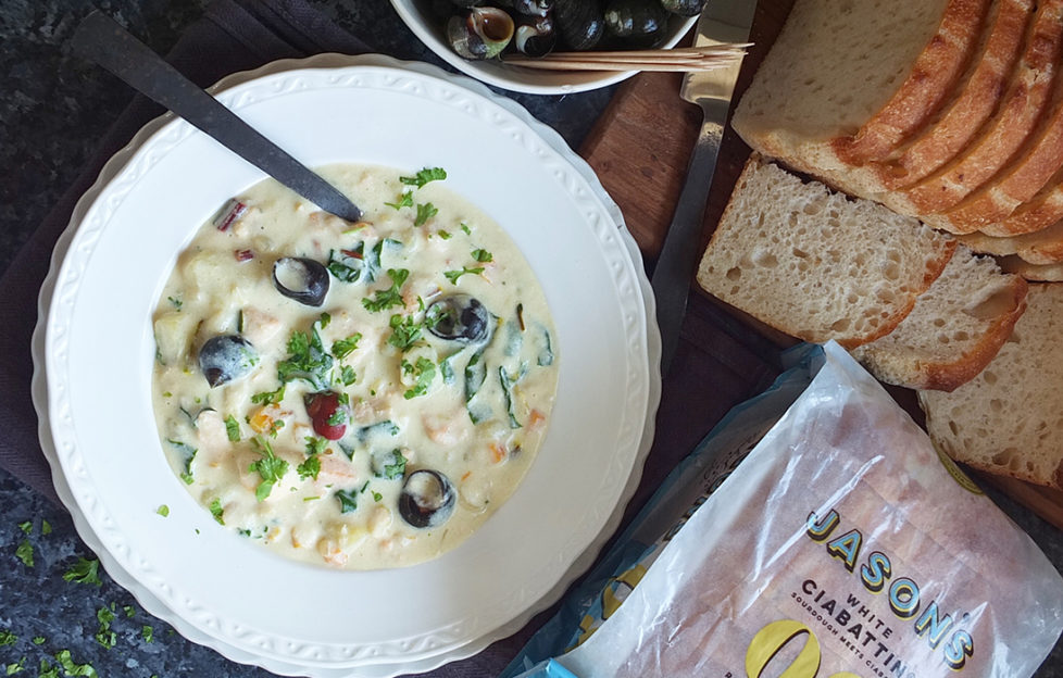 Bowl of thick creamy chowder with sliced bread