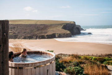 Couple in hot tub overlooking beach