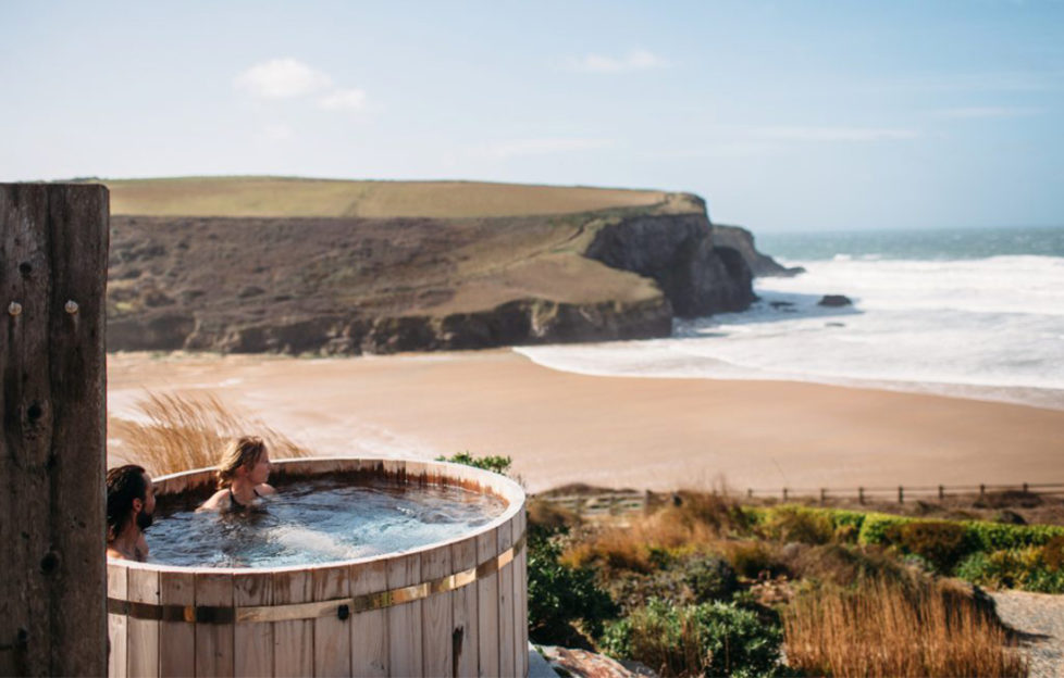 Couple in hot tub overlooking beach