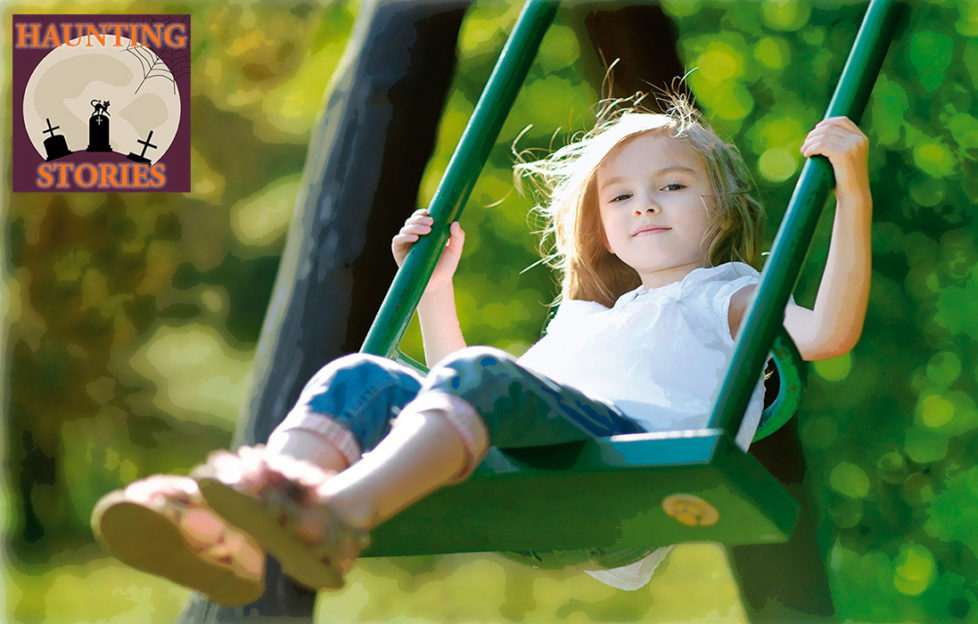 Girl aged 5 on swing, bushes behind