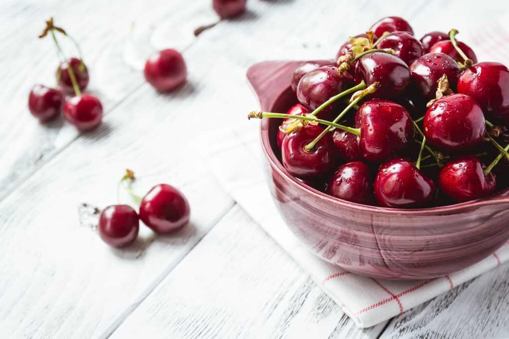 Cherries. Cherry. Cherries in color bowl and kitchen napkin. Red cherry. Fresh cherries. Cherry on white background. healthy food concept; 