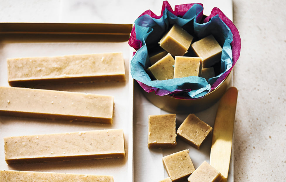 Fudge cut into bars and cubes, some in a tissue lined gift box