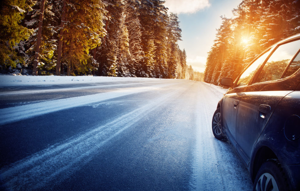 car on winter road in the morning;