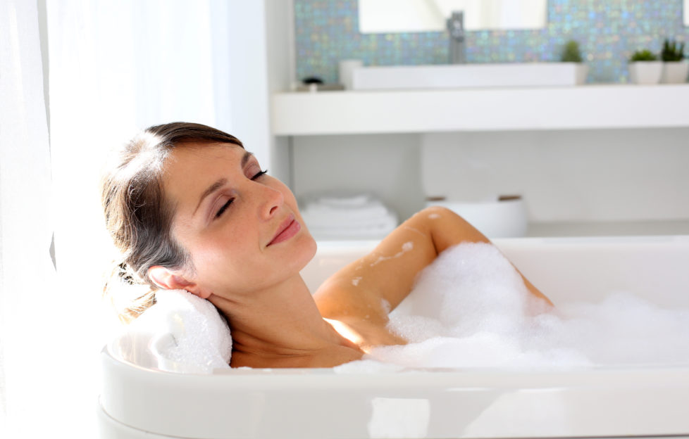 Beautiful woman relaxing in bathtub;