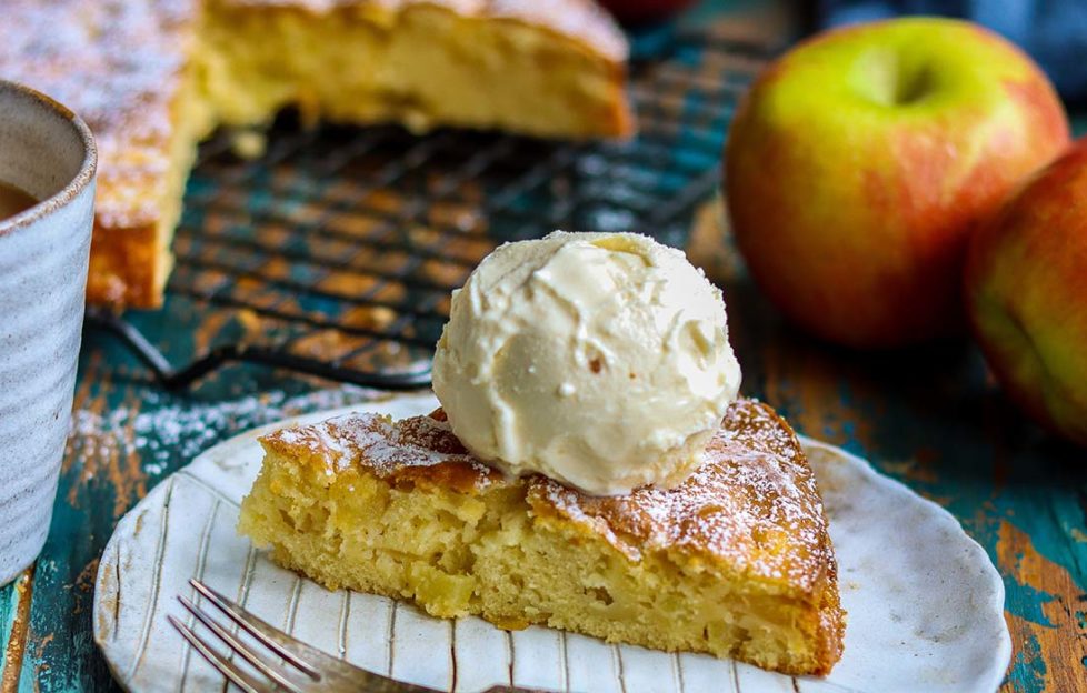 Slice of rum and apple cake with a scoop of ice cream