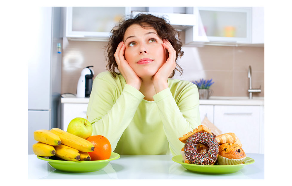 Lady looking at two bowls of food Pic: Shutterstock