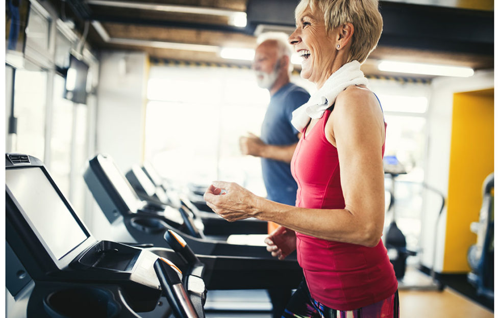 Senior people running in machine treadmill at fitness gym club;