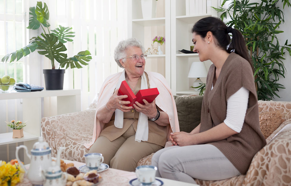 Daughter giving mum a gift on Mother's Day Pic: Shutterstock