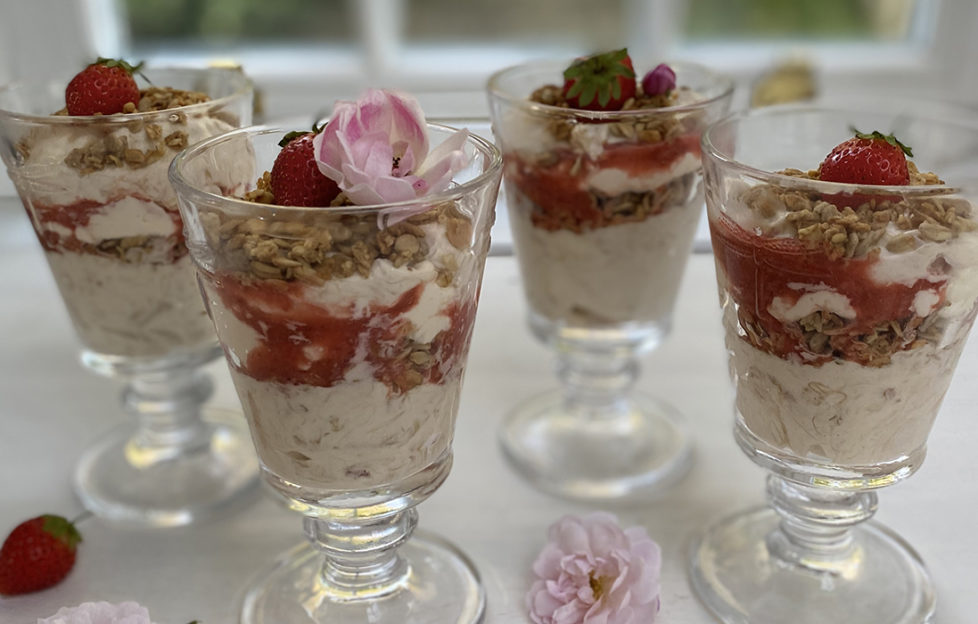 4 sundae glasses with rhubarb fool topped with pink flowers