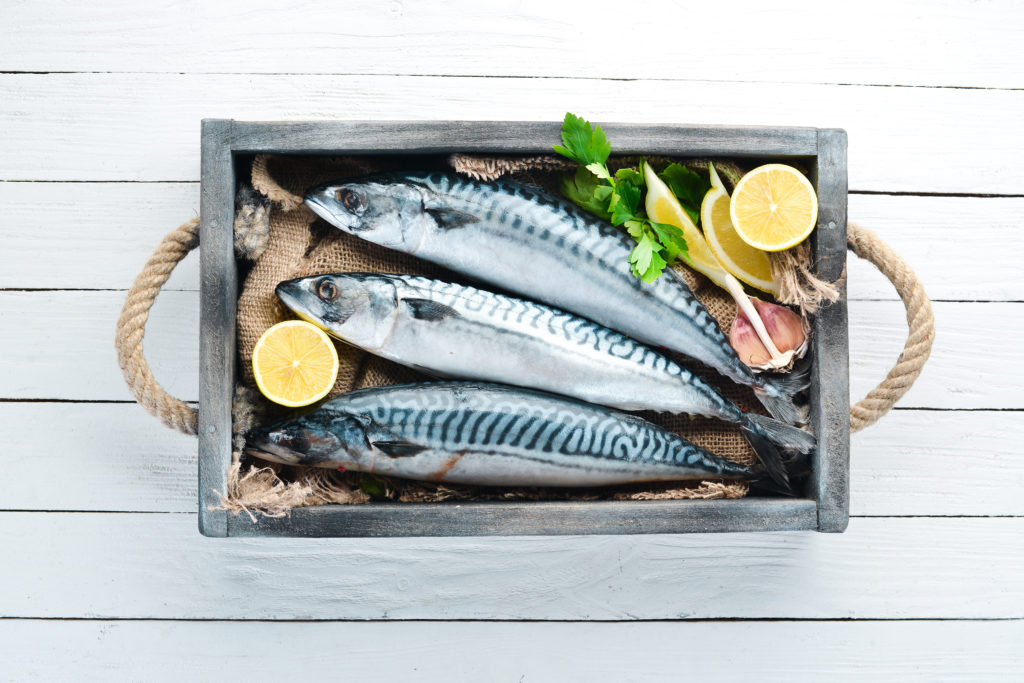 Mackerel on a white wooden background. Raw fish Top view. 