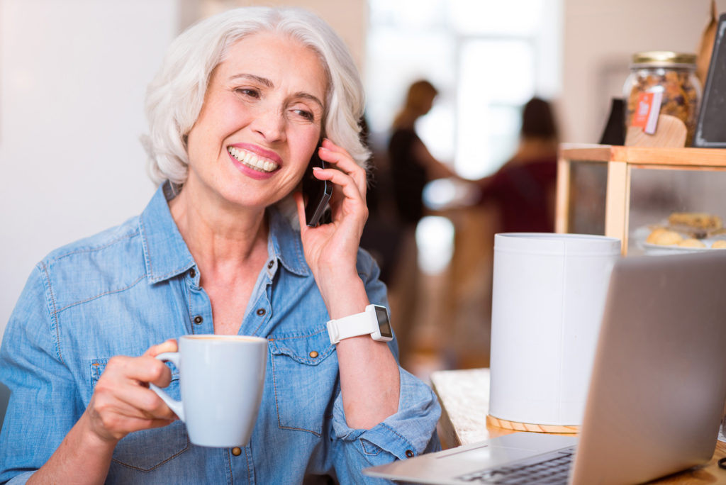 Positive woman talking on cell phone; 