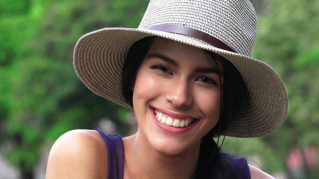 Smiling woman wearing a straw hat