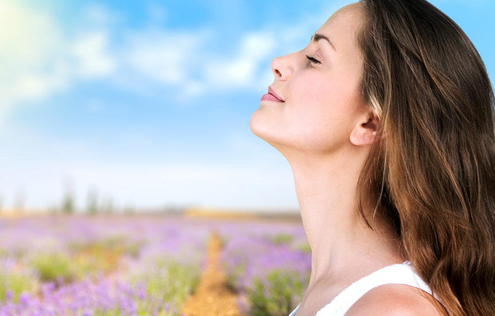 Woman taking deep breath outdoors